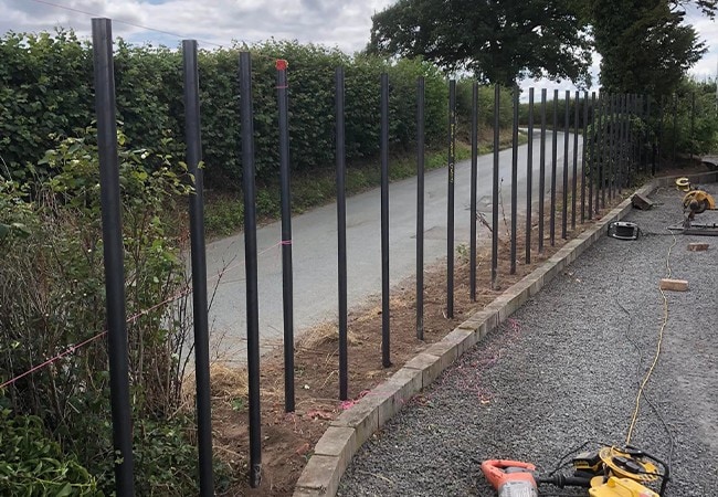 Poles to start woven process by road.