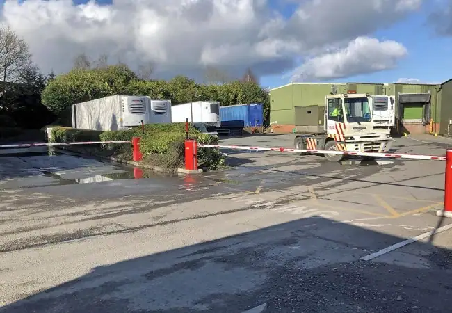 Road with a closed red and white raising barrier.