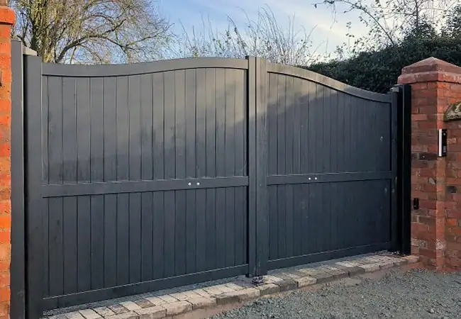 Tall grey wooden fence in front of house
