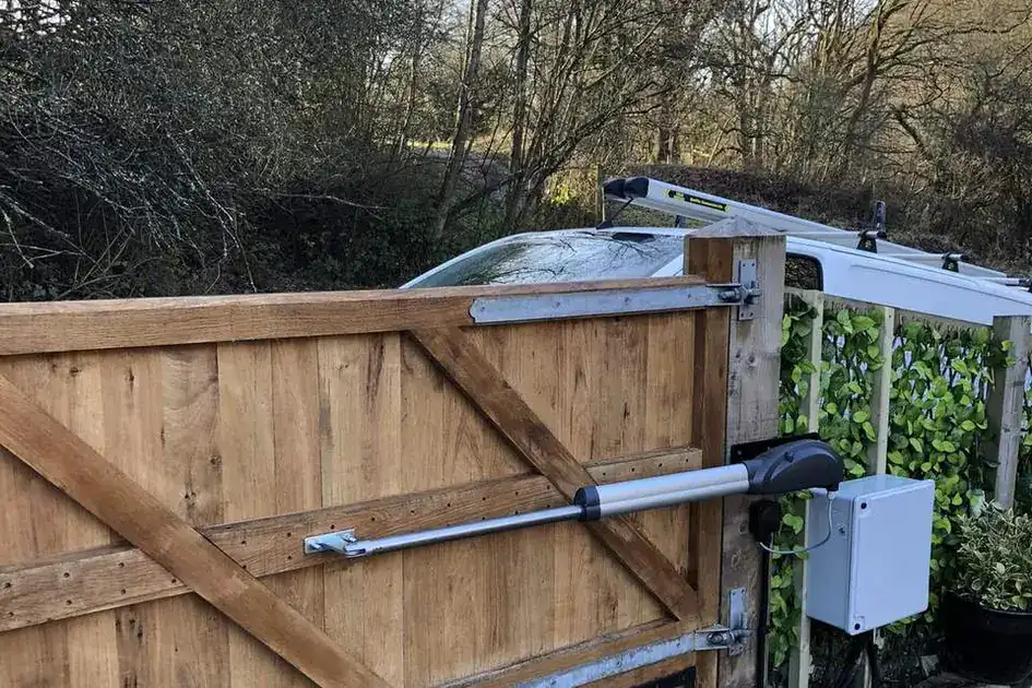 Ram arm and control box fitted to a timber driveway gate
