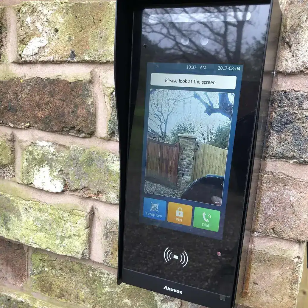 Video intercom with a touch screen mounted on a brick gate pillar
