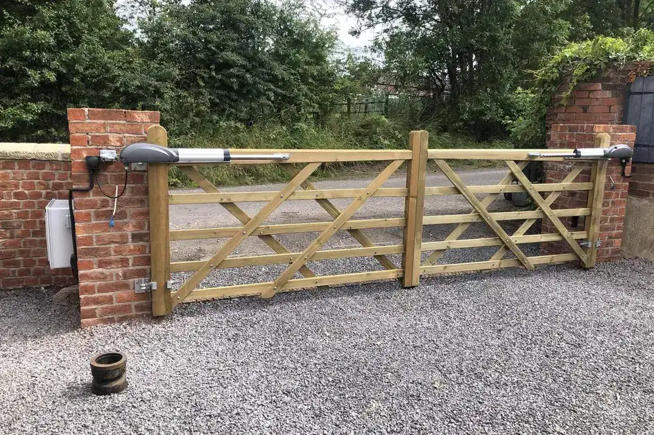 Timber five-bar gates hung on brick piers