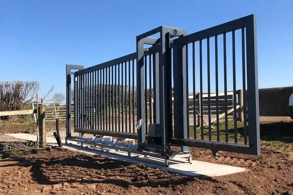 Steel sliding gate on a new concrete track at a farm entrance
