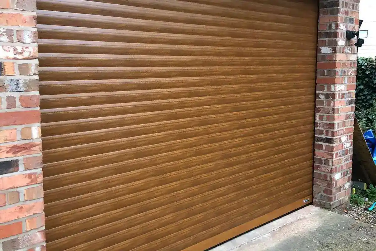 Irish Oak effect roller garage door on a brick garage